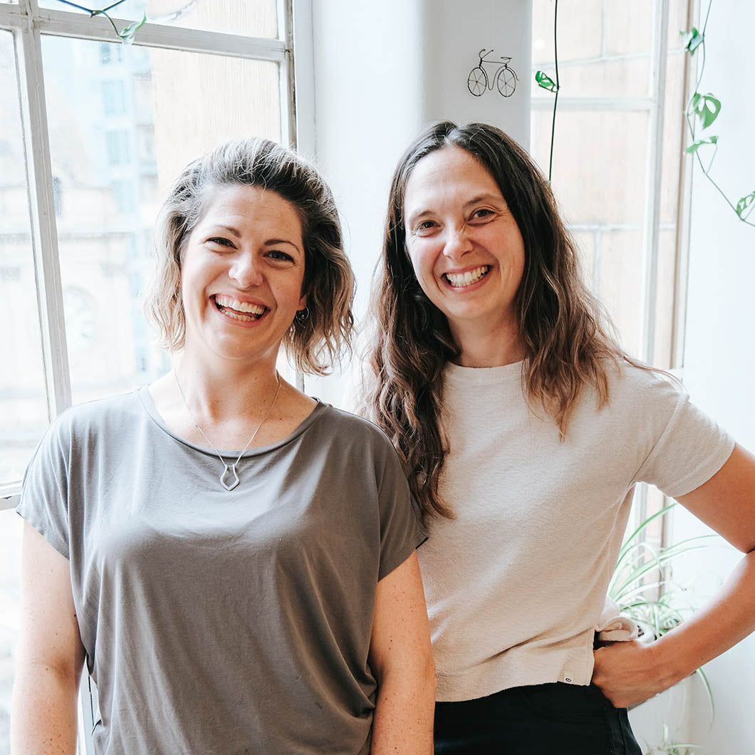 Jenna & Megan standing by the window of their studio