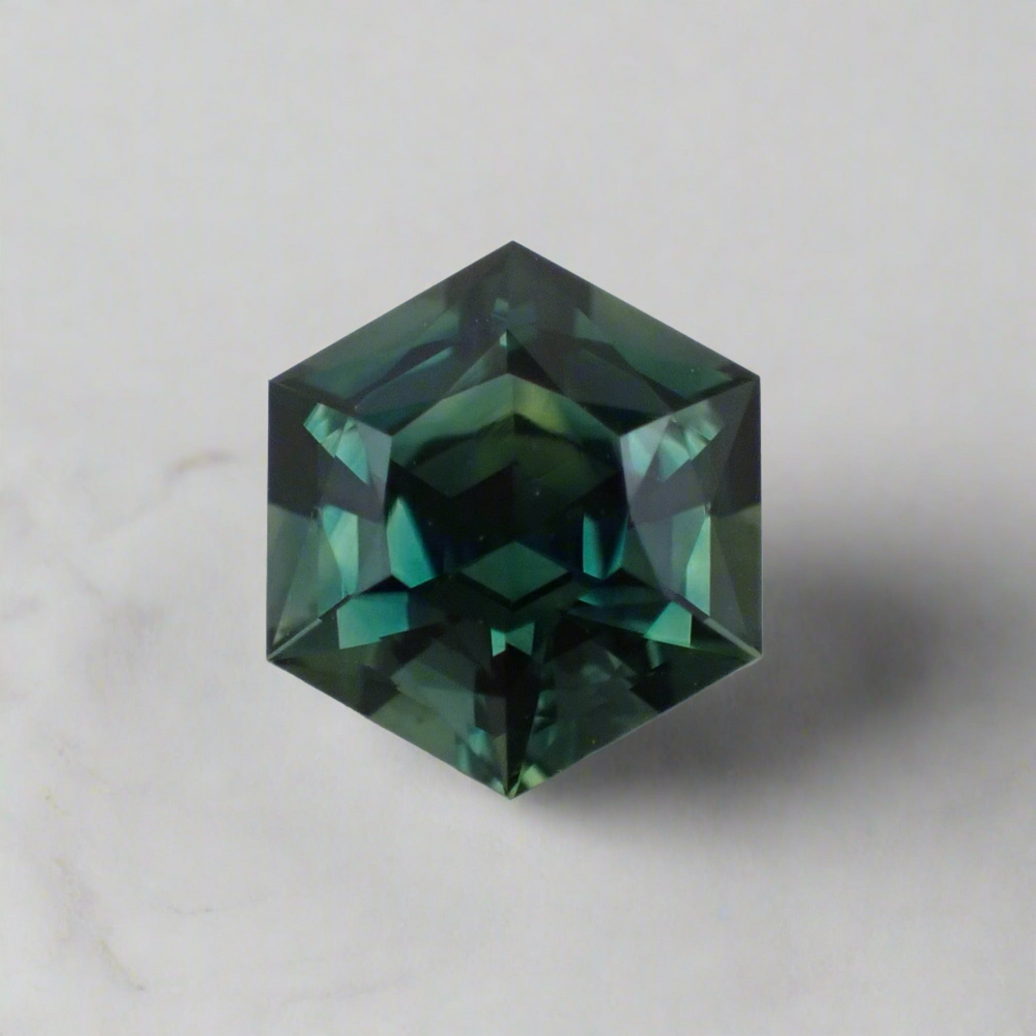 Close up of a teal hexagonal sapphire.