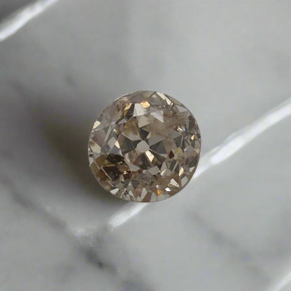 a light champagne diamond with uneven, old cut facets