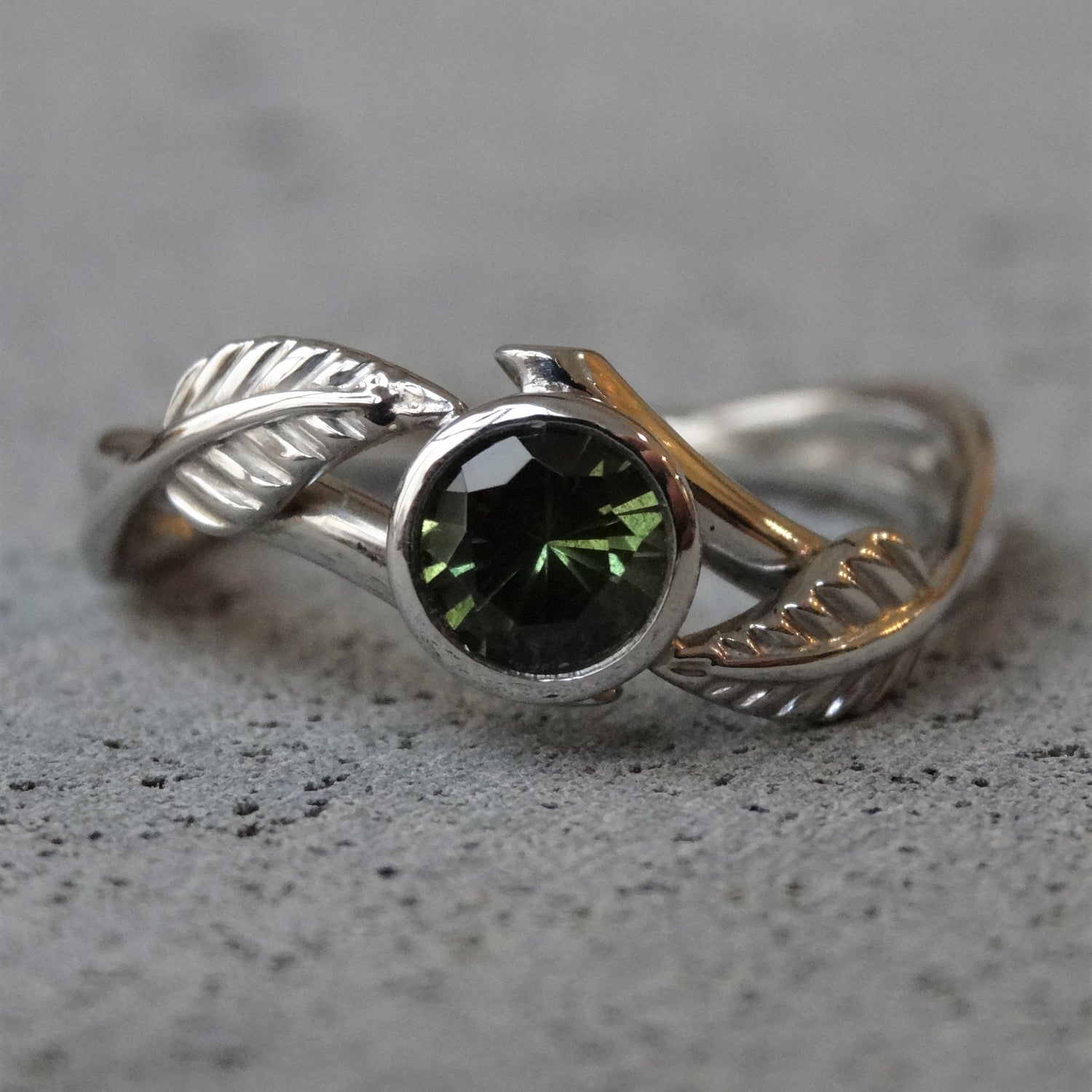 Green Australian sapphire and recycled platinum engagement ring with leaf detail