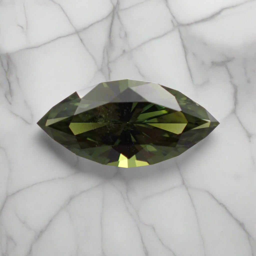 Green gemstone on a light gray background
