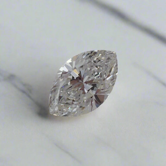 a close up photo of a half carat marquise cut diamond