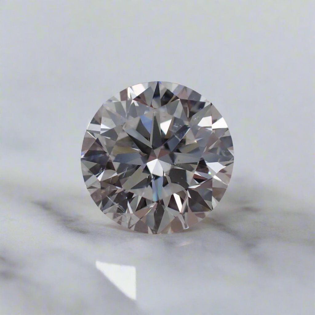 a round white diamond with small feather like inclusions rests on a table