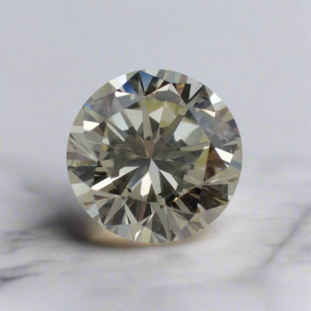 A white diamond with a very slight yellow tint rests on a white surface.